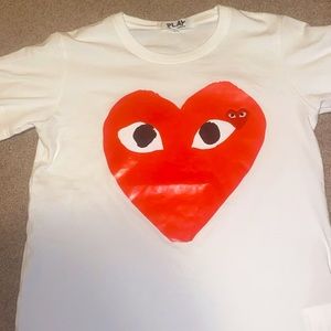 a white commes des garcon short sleeve shirt